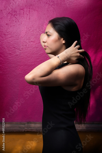 Sensual latina in magical town in profile with black dress