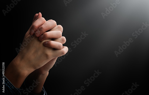 praying hands in the dark