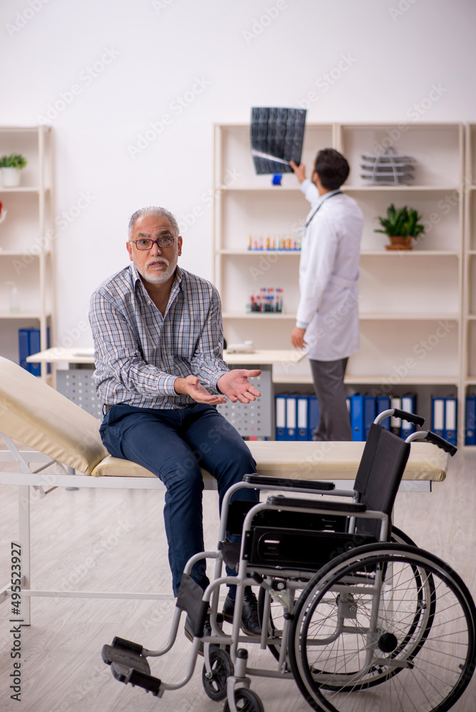Old injured man visiting young male doctor radiologist Old injured man visiting young male doctor radiologist