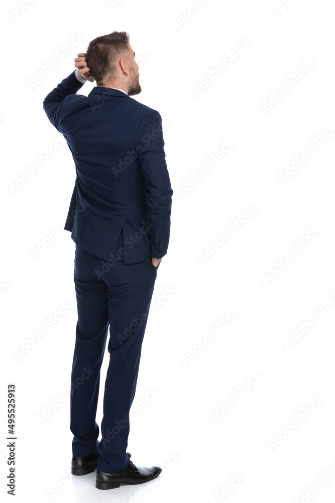businessman scratching his head and pondering a decision businessman scratching his head and pondering a decision
