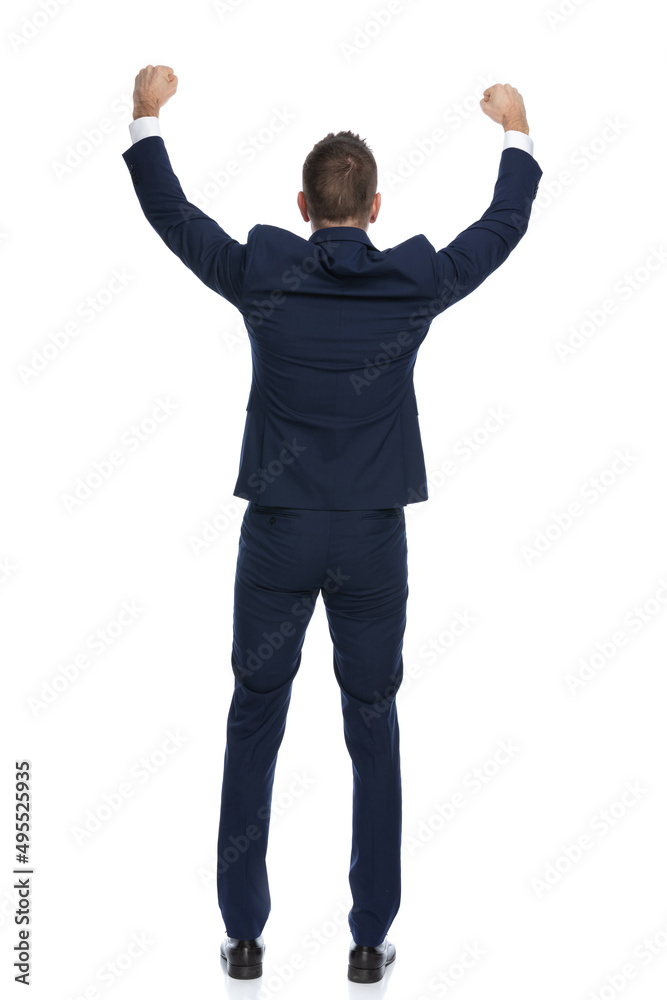 businessman celebrating success and turning his back at the camera businessman celebrating success and turning his back at the camera