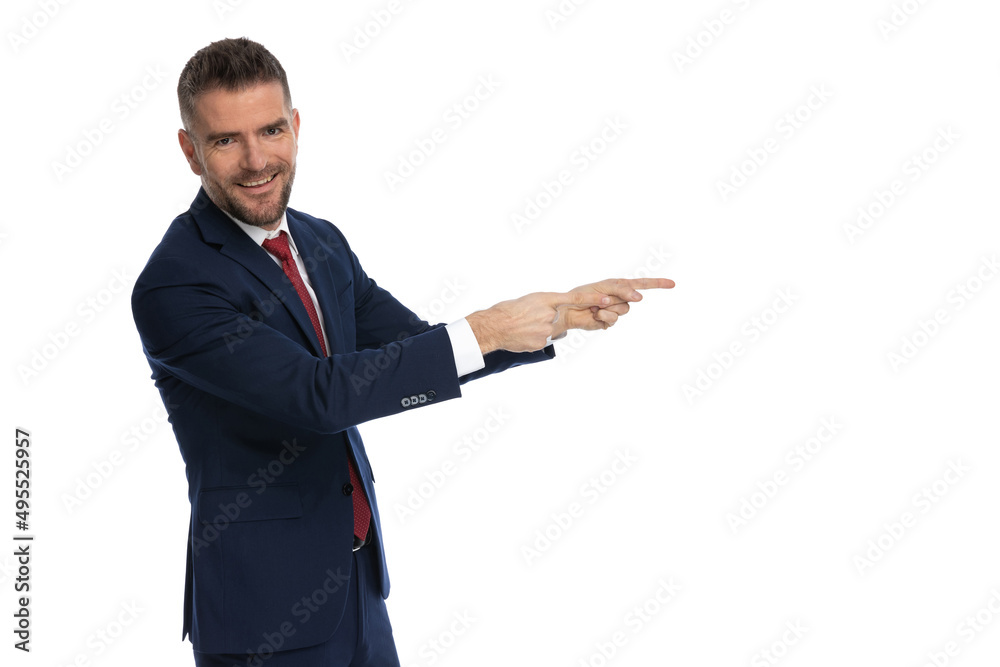 businessman pointing to the side and smiling at the camera businessman pointing to the side and smiling at the camera