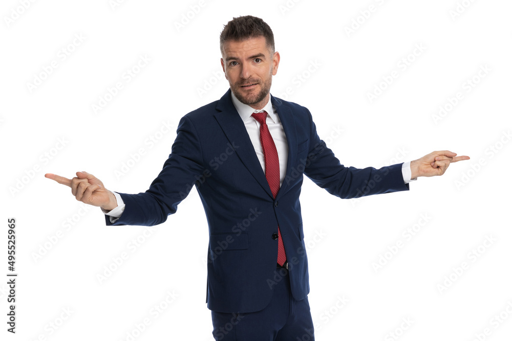 attractive businessman pointing in two separate ways attractive businessman pointing in two separate ways