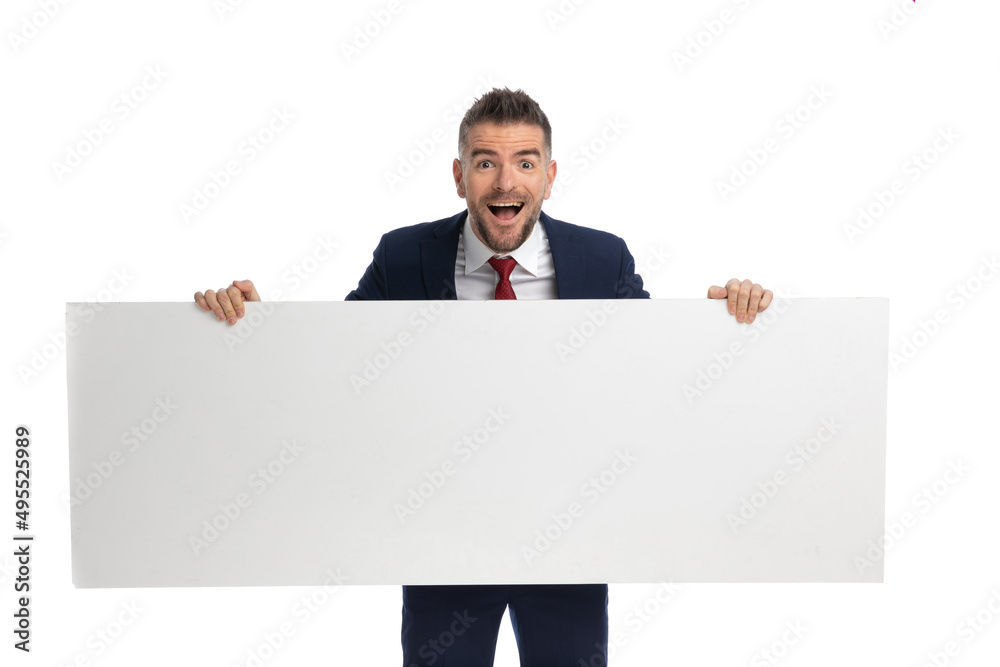 excited businessman presenting an horizontal billboard excited businessman presenting an horizontal billboard