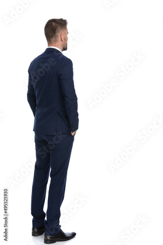 businessman waiting in line with his hands in pockets