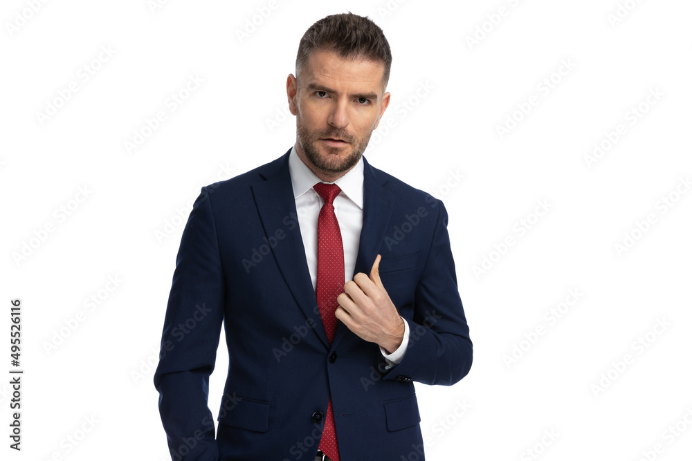 businessman with tough attitude is adjusting his suit businessman with tough attitude is adjusting his suit