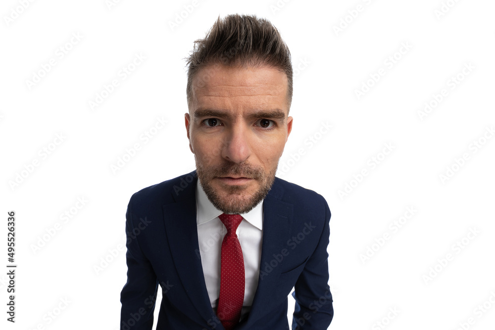 handsome businessman leaning forward and staring at the camera handsome businessman leaning forward and staring at the camera