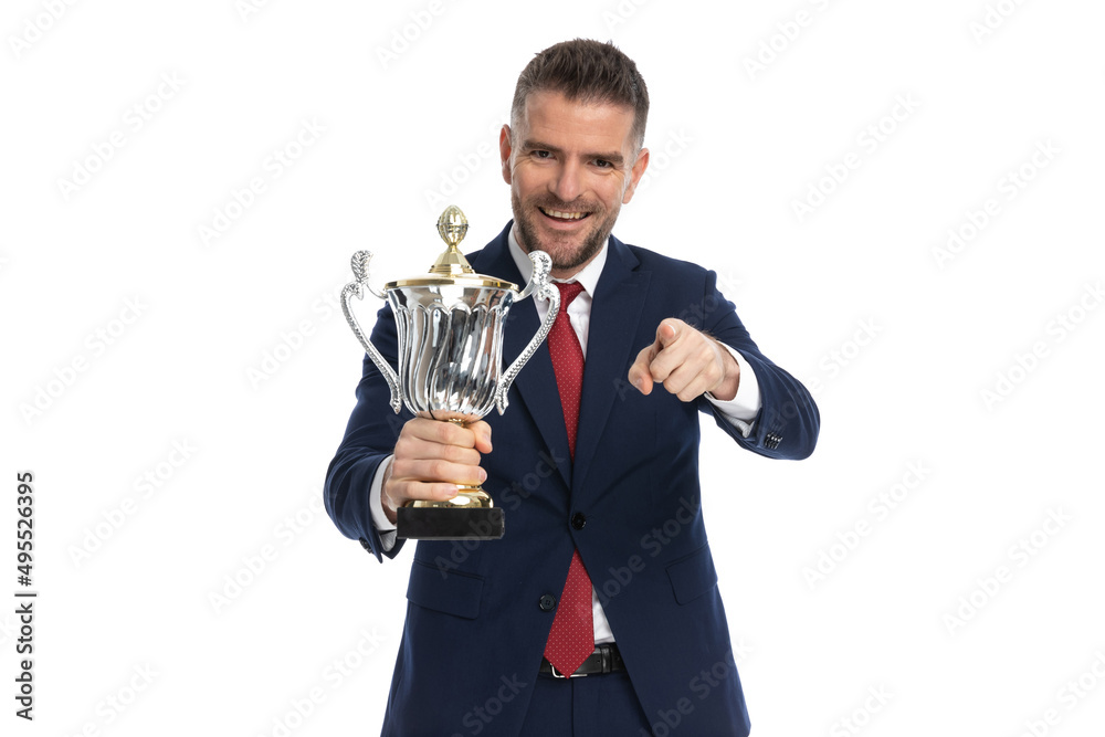 businessman pointing at the camera and raising a cup businessman pointing at the camera and raising a cup