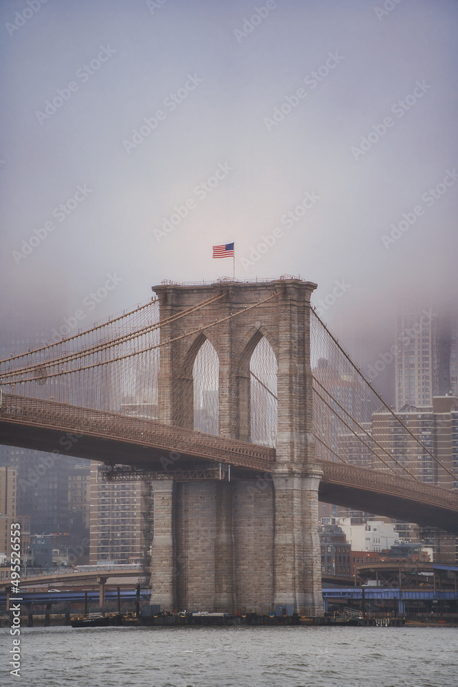 Brooklyn bridge in a foggy day, New York.