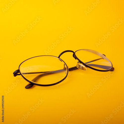 Eye glasses isolated on yellow background.