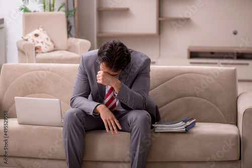 Young male employee working from home during pandemic