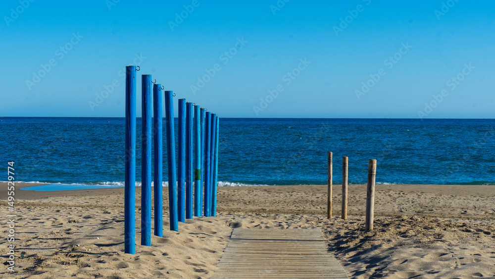 BEACONS AND WOODEN WALKWAY ACCESS TO THE BEACH in malaga, mediterranean sea BEACONS AND WOODEN WALKWAY ACCESS TO THE BEACH in malaga, mediterranean sea