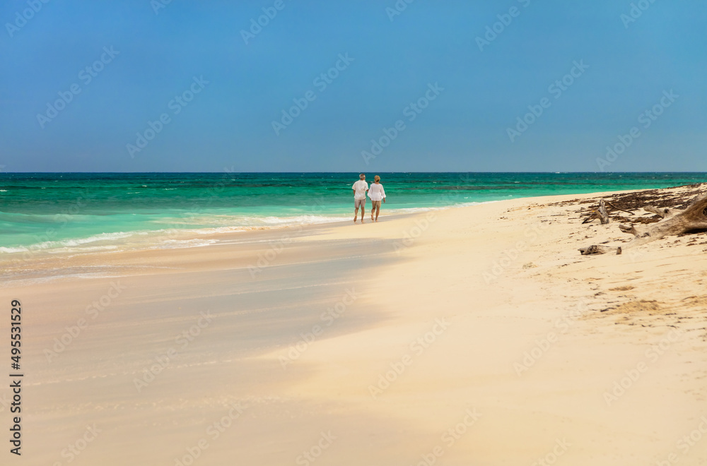 Romantic getaway for retired couple walking by ocean