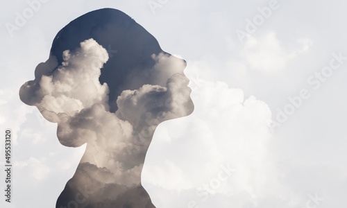 Multiple exposure clouds Woman mental health and weather dependent concept. photo