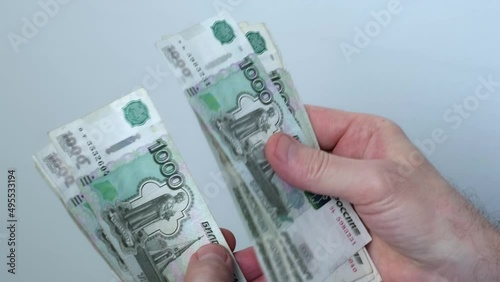 Men's hands count money, the currency is the Russian ruble. Concepts of finance and wealth. Banknotes of 1000 rubles in the hands of men. Investments, saving money.