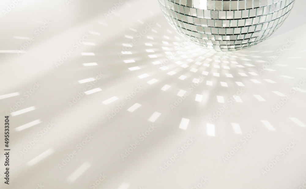 Disco ball on a white background with shadows and casts rays of bright  light. Glare and light reflection effect. Copy space. Photos | Adobe Stock