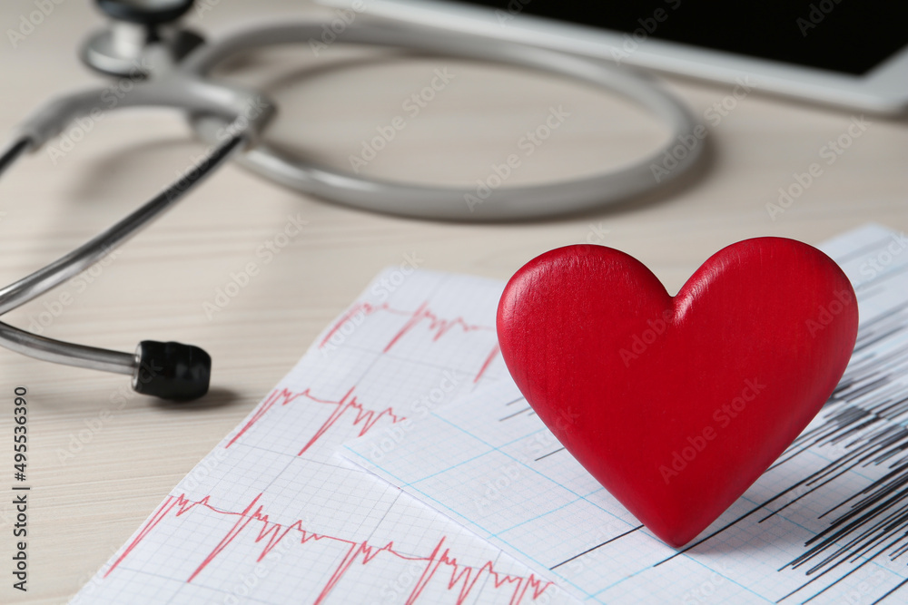 Red heart with cardiogram and stethoscope on white wooden table, closeup. Cardiology concept Red heart with cardiogram and stethoscope on white wooden table, closeup. Cardiology concept