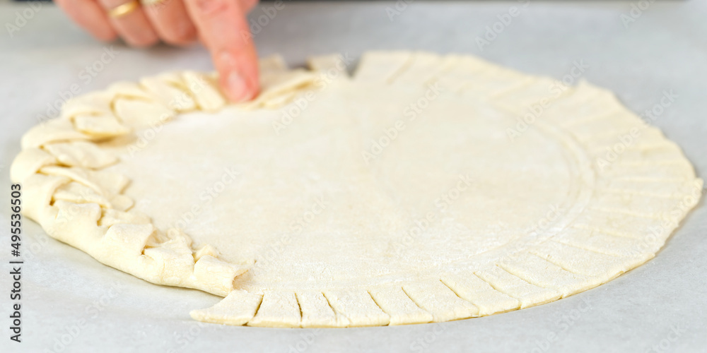 Pizza making process. Top view of pizza dough base. Home-baking pizza with a braided pie crust. close up Pizza making process. Top view of pizza dough base. Home-baking pizza with a braided pie crust. close up
