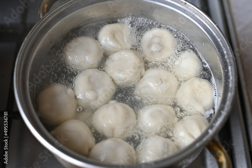 khinkali are boiled in a saucepan, boiled, the water is boiling