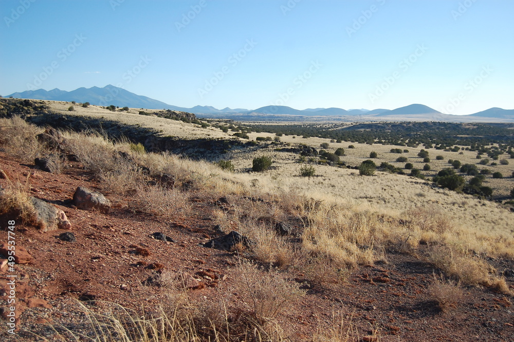 The vast desert landscape of the Colorado Plateau, with the San Francisco Peaks, Mount Humphreys in the background, Wupatki National Monument, Coconino County, Flagstaff, Arizona. The vast desert landscape of the Colorado Plateau, with the San Francisco Peaks, Mount Humphreys in the background, Wupatki National Monument, Coconino County, Flagstaff, Arizona.
