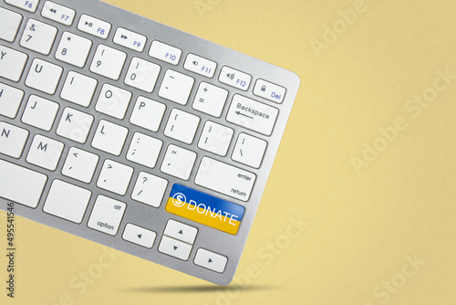 Keyboard key with Ukraine flag and donate text on yellow dark background. Donation for Ukraine concept 