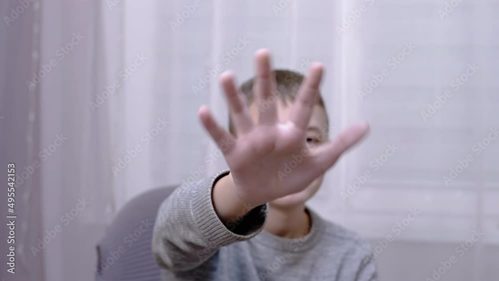 Sad Child Waving Hands Goodbye, Hello, Bye while Sitting on an Armchair ...