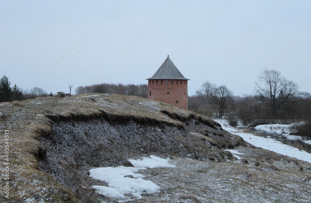 Old red brick tower on hill at winter Old red brick tower on hill at winter