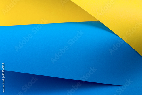 Blue and yellow paper is curved by a wavy line. Background of shape and curve line. Abstract creative design.