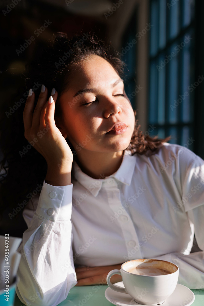 serious curly girl portrait with great sun light. Woman closeup. asian caucasian pretty young woman eyes and lips serious curly girl portrait with great sun light. Woman closeup. asian caucasian pretty young woman eyes and lips