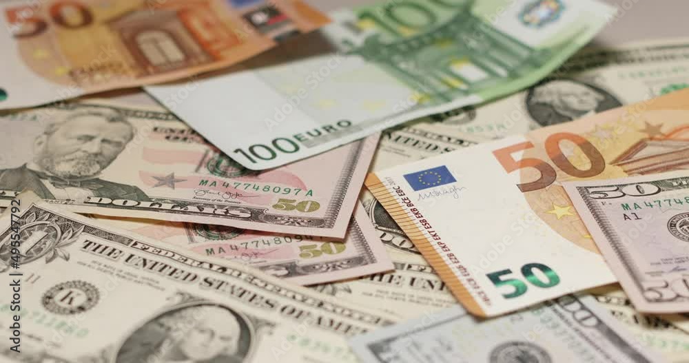 Piled up Euro and Dollar banknotes, 50 Euro and fifty Dollar bills Piled up Euro and Dollar banknotes, 50 Euro and fifty Dollar bills