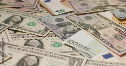 Forex exchange of USD and EUR. US Dollar banknotes on top of Euro banknotes.