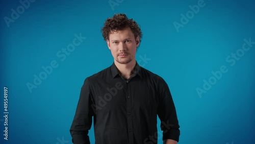 Cunning clever business male portrait posing isolated blue studio man sarcastic nervous