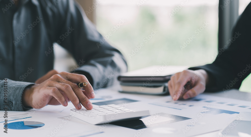 Close-up of Businessman hands pointing at turnover graph while discussing it on wooden desk with pen in meeting room, Business financial working concept, business people pointing at business document,