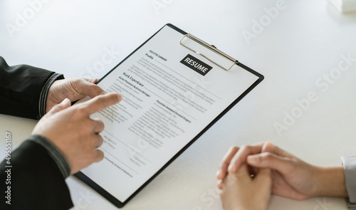 Close up businessman hands holding pen with document at meeting. Man making decision on business deal. Good business partners negotiation at job interview in office.