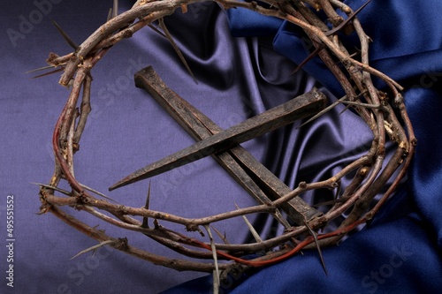 Christian crown of thorns with metal nails on a desk