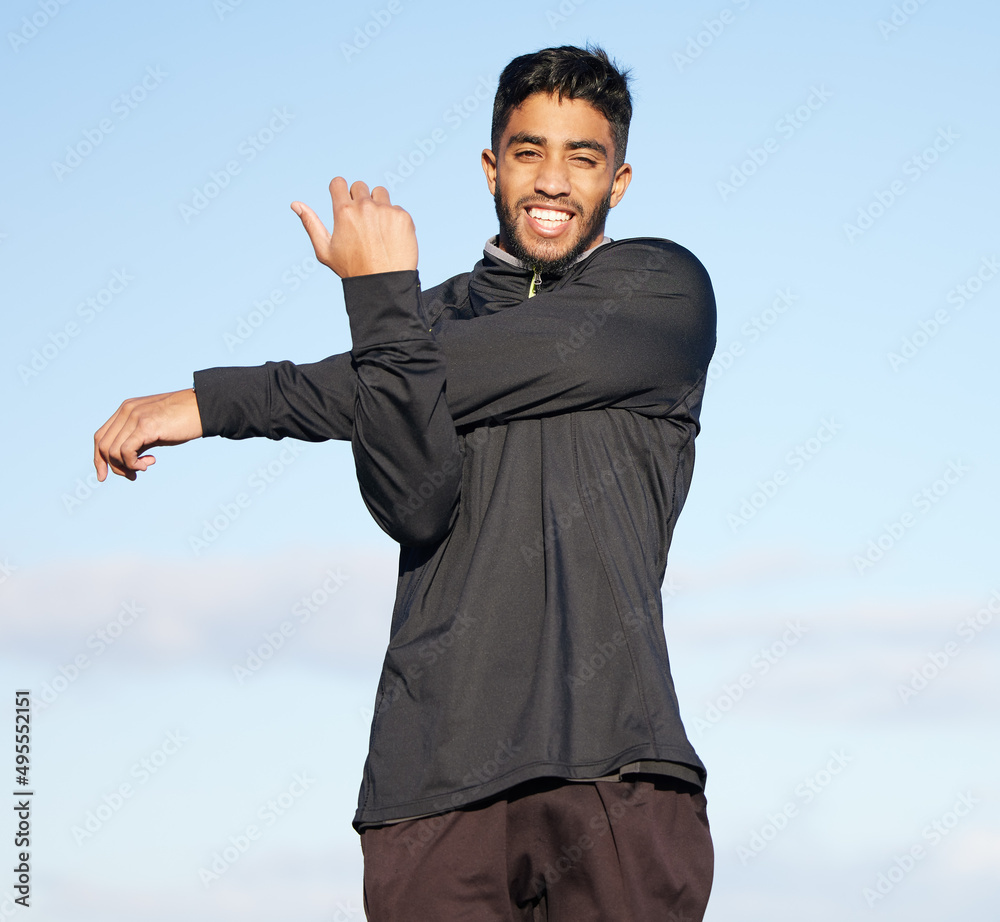 Stretching is just as important as the workout. Shot of a young man stretching his arms before his morning run. Stretching is just as important as the workout. Shot of a young man stretching his arms before his morning run.