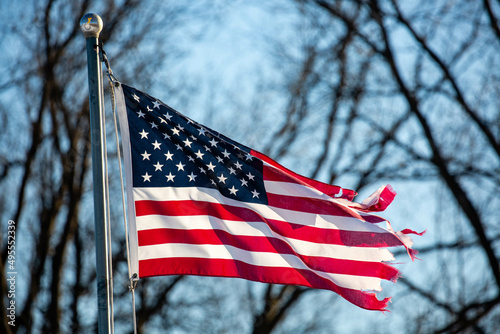 Εκτύπωση καμβά Close-up of a badly tattered American flag flying from flagpole outside
