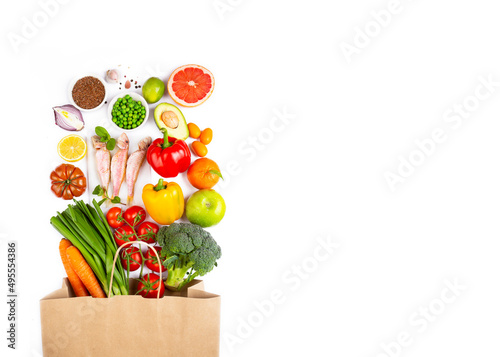 Healthy food background. Healthy vegan vegetarian food in paper bag vegetables on white, copy space. Shopping food supermarket and clean vegan eating concept.