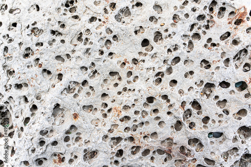 texture of porous stones on the beach, nature, natural phenomena, brown gray stones photo