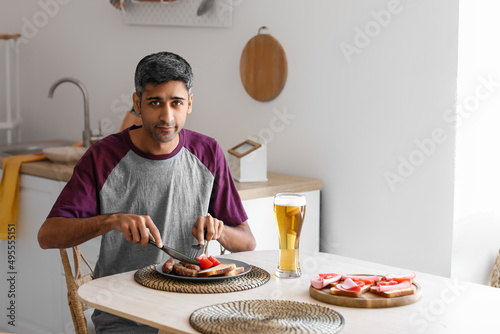 Handsome man having dinner ...