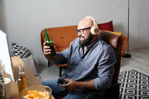Bald man drinking beer and ...