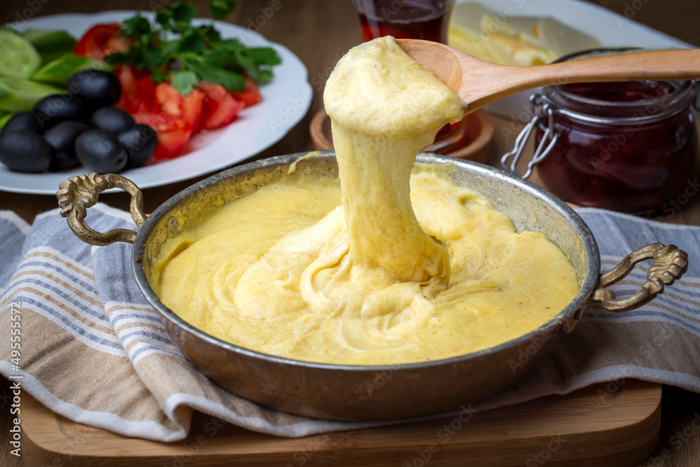 Mihlama (kuymak) is a famous traditional food from Black Sea region in Turkey. It is prepared with corn meal and cheese and served hot.