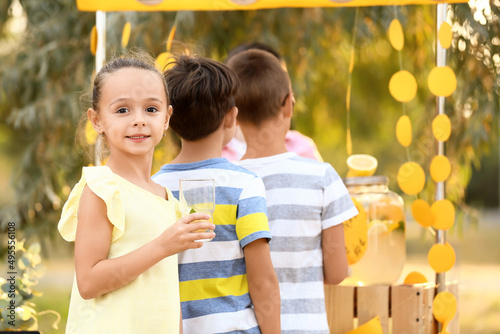 Cute children buying lemona...