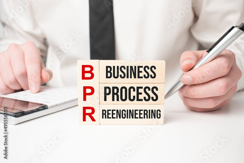 BPR word written on wood block, business concept. BPR - short for Business Process Reengineering photo