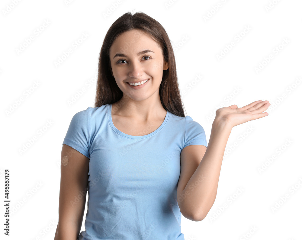 Young woman with applied nicotine patch showing something on white background. Smoking cessation Young woman with applied nicotine patch showing something on white background. Smoking cessation