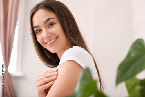 Young woman with applied nicotine patch at home. Smoking cessation photo