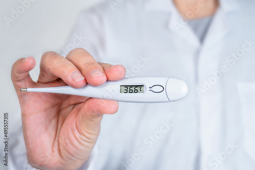 Doctor shows a thermometer