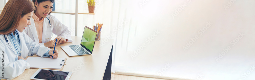 Banner hands of two women doctor medical lab discussing together healthcare teamwork. Panorama Two asian women doctors meeting write prescription medical clinic office using laptop with copy space. Banner hands of two women doctor medical lab discussing together healthcare teamwork. Panorama Two asian women doctors meeting write prescription medical clinic office using laptop with copy space.
