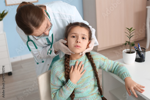 Doctor examining little gir...