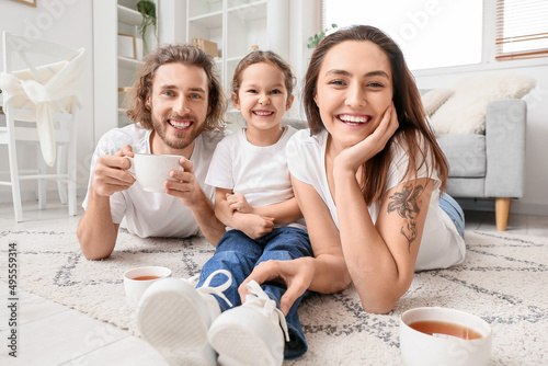 Young family with cups of t...